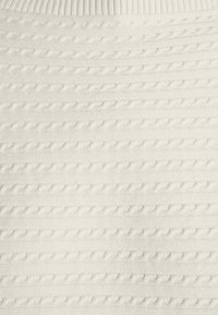 White knit sweater featuring a textured pattern of raised horizontal lines and small braids. Circular neckline with a ribbed trim.