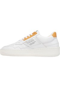 White leather sneaker with a textured yellow accent on the heel, flat white rubber sole, and visible perforations on the toebox.