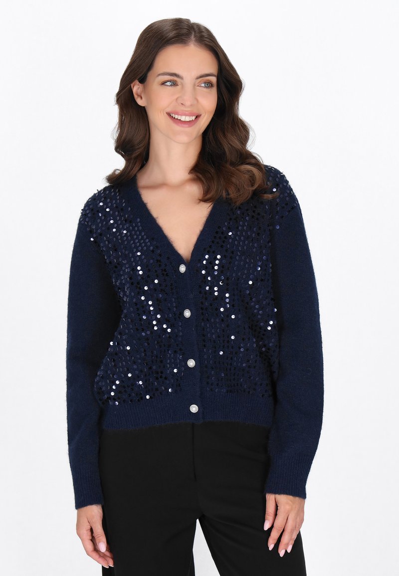 Cardigan lavorato a maglia blu navy con scollatura a V, decorato con paillettes sul davanti e chiusure con bottoni argento al centro.