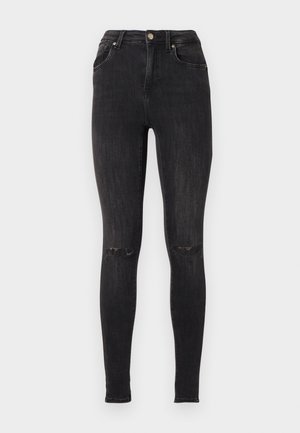 Jean skinny noir en denim, avec une taille haute, des détails déchirés aux genoux et un design classique à cinq poches.