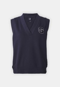 Tmavě modrý bezrukávový svetr s výstřihem do V, s vyšitým logem "G" na levé straně. Měkká látka a přiléhavý střih.