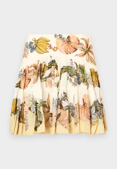 Floral printed tiered skirt in cream, featuring large colorful illustrations of flowers and fruits. Soft fabric, ruffled hem, and elastic waistband.