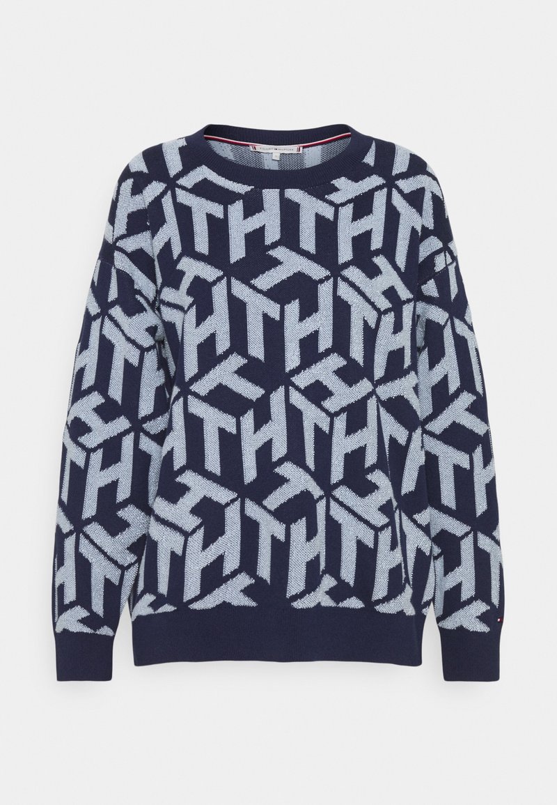Pull bleu marine avec motif géométrique bleu clair comportant des lettres entrelacées "TH" partout, col rond et manches longues.