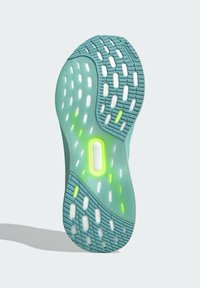 Semelle de chaussure en bleu-vert avec matériau en caoutchouc. Comprend une prise texturée avec des accents blancs et verts fluo, des découpes ventillées et un logo circulaire.