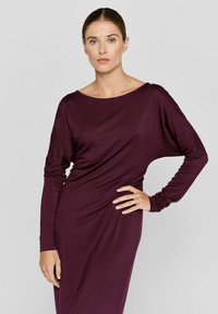 Burgunderfarbenes Langarmkleid mit weitem Schalkragen, drapiertem Design und glatter Textur. Verfügt über eng anliegende Manschetten und eine entspannte Passform.