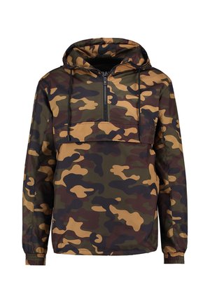 Kamuflāžas vējjaka zaļā, brūnā un bēšā krāsā. Aprīkota ar kapuci, pusgaru rāvējslēdzēju priekšpusē un elastīgiem aprocēm. Audums ir ūdensizturīgs.