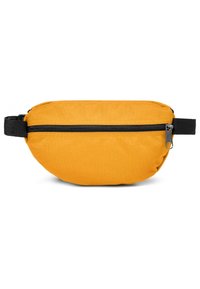 Sac banane compact en tissu jaune avec fermeture éclair noire et sangle noire réglable sur fond blanc.