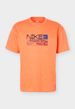 Orange short-sleeve Nike basketball t-shirt with black and blue logo, swoosh, basketball graphic, and "Just Do It" slogan on front.