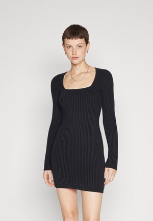 Black ribbed long-sleeve dress with a square neckline, fitted shape, and textured fabric, designed for a slim fit.