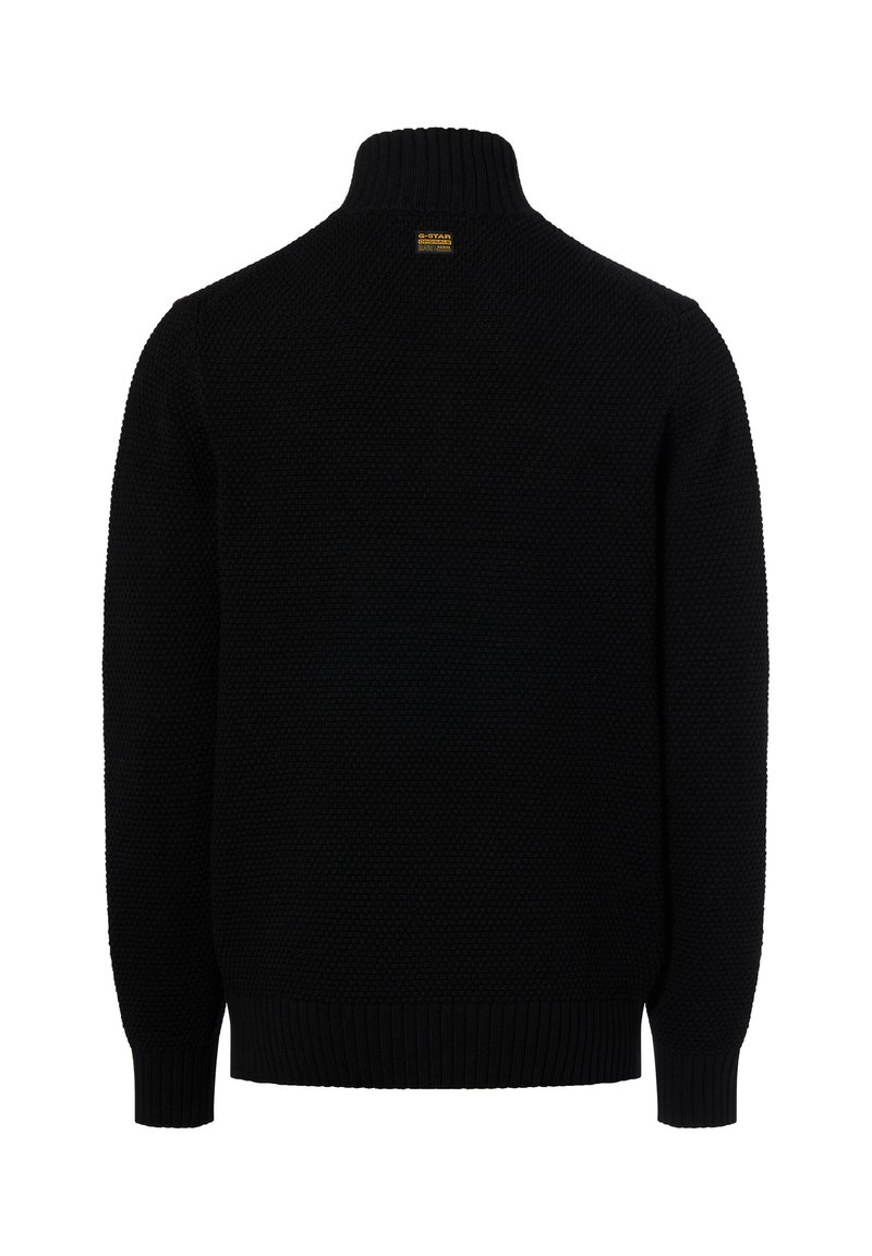Maglione nero in maglia con collo alto, caratterizzato da un motivo testurizzato e polsini a costine. L'etichetta sul retro del collo identifica il marchio.