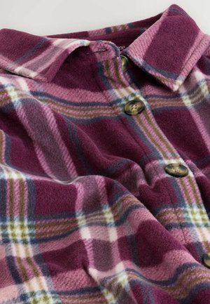 Fleece plaid shirt in shades of purple, pink, and green with a collar and two brown buttons. Soft texture with a checkered pattern.