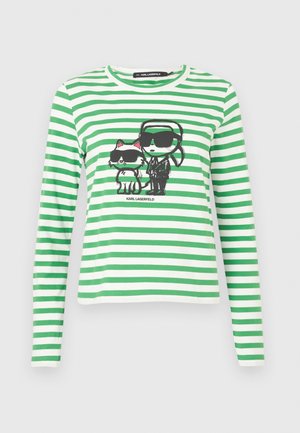 Zeleno-bílý pruhovaný dlouhý rukáv s grafikou postavy a kočky, obě nosí sluneční brýle, s kulatým výstřihem.