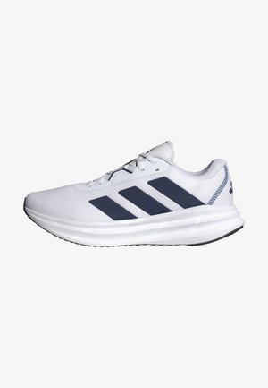 White athletic shoe with a textured mesh upper, features three navy stripes, padded collar, and cloud-like white midsole. Rubber outsole.