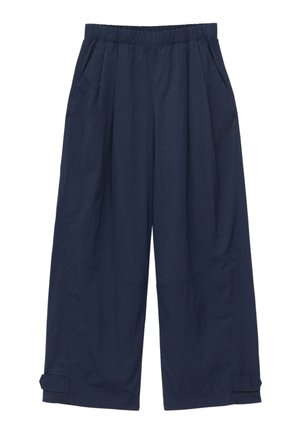 Pantalon large bleu marine avec taille élastique, poches latérales et détails de brides ajustables aux ourlets.