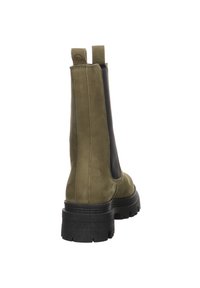 Green suede ankle boots with black elastic side panels, a rounded toe, and a textured black rubber sole, featuring pull tabs at the back.