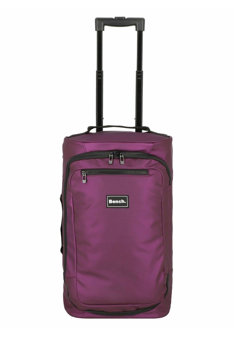 Zaino con ruote viola dotato di manico estensibile, grande tasca frontale e chiusure con zip. Realizzato in materiale sintetico liscio. Dettagli neri.