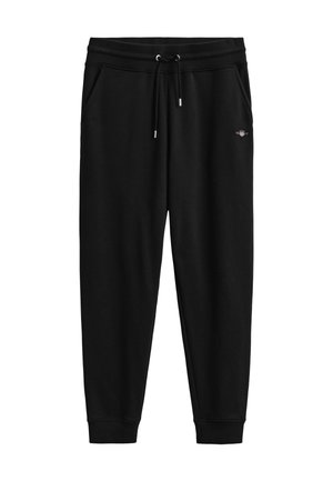 Schwarze, zulaufende Jogginghose mit elastischem Bund, Kordelzug, Seitentaschen, Bündchen an den Knöcheln und kleinem gesticktem Logo am rechten Oberschenkel.