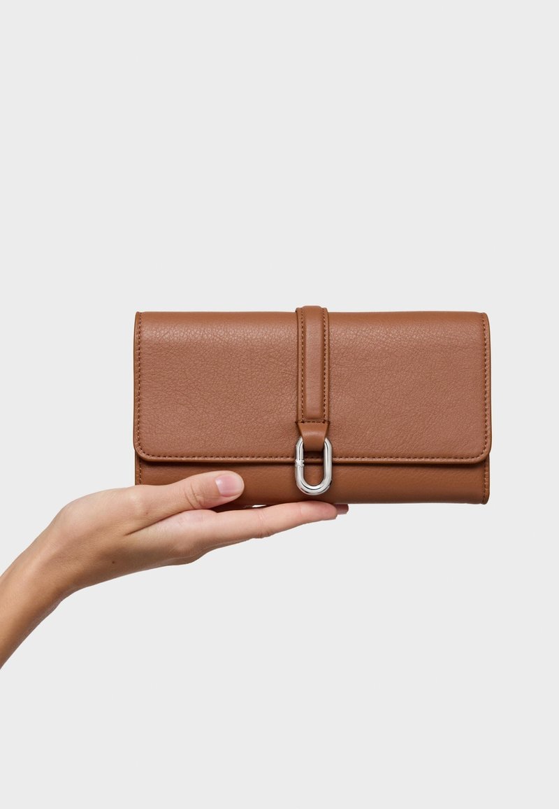Brown leather wallet with a textured finish, featuring a silver hardware clasp and a front flap secured by a leather strap.