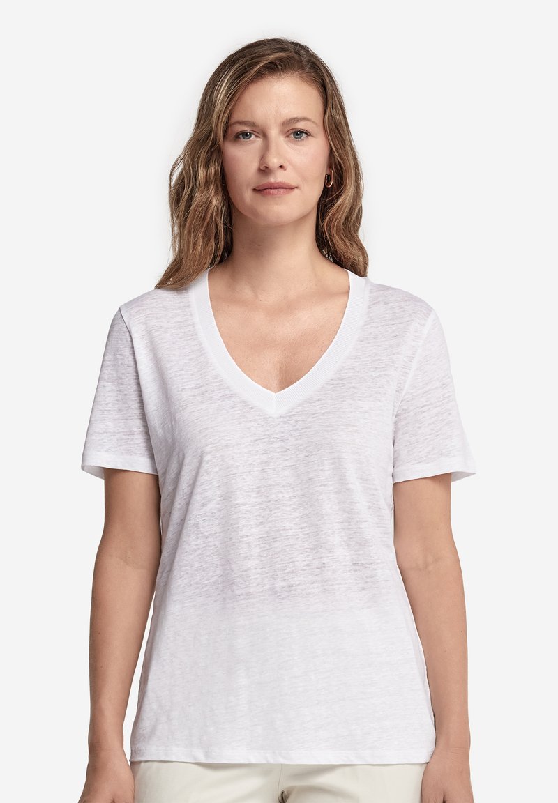 Vit V-ringad T-shirt i lätt, texturerat tyg. Korta ärmar och avslappnad passform, med synlig sömnad längs halsringningen.