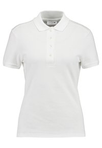 Polo shirt blanc à manches courtes en coton Texturé, avec un col classique, une patte de boutonnage à trois boutons et un logo brodé sur la poitrine.