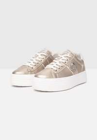Metallic gold sneakers with a smooth finish, white platform sole, round toe, and decorative heart hardware detail near the laces.