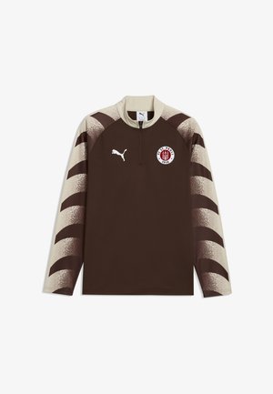 Brązowa sportowa bluzka z długim rękawem z beżowym kołnierzem i rękawami z ciemnobrązowymi skośnymi paskami, logo Puma oraz emblematem FC St. Pauli 1910 na piersi.