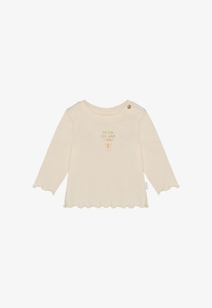 Crèmekleurige top met lange mouwen, ronde hals, gegolfde zoom en knoopdetail. Voorzien van de tekst "Enjoy The Good Times" in zachtbruin.