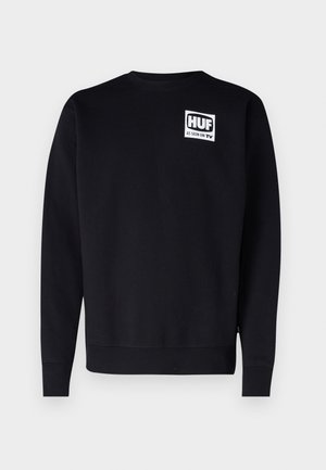 Sort sweatshirt lavet af bomuldsblanding, med rund hals, lange ærmer, og et hvidt kvadratisk grafik med "HUF AS SEEN ON TV" på brystet.