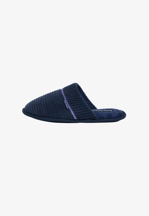 Marineblauwe slippers met geribbelde textuur, paarse accentband, gesloten achterkant, gevoerde zool en stoffen bovenkant voor comfort en stijl.