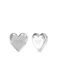 Orecchini a forma di cuore in tonalità argento con incisione "GUESS EST. 1981", caratterizzati da una finitura liscia e lucida e accenti hardware sottili.