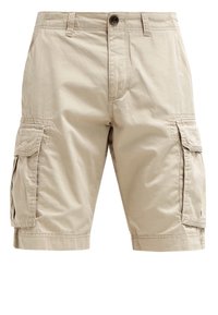Shorts cargo beiges en coton léger. Comprend plusieurs poches latérales et des détails surpiqués. Longueur jusqu'à mi-cuisse avec une fermeture à bouton.