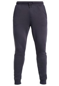 Mörkgrå sweatpants i mjukt tyg, med elastisk midja och dragsko, sidofickor och ribbade manschetter.