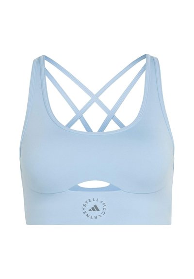 Light blue sports bra with crisscross thin straps at the back, front cutout below bust, and circular logo centered on the band.