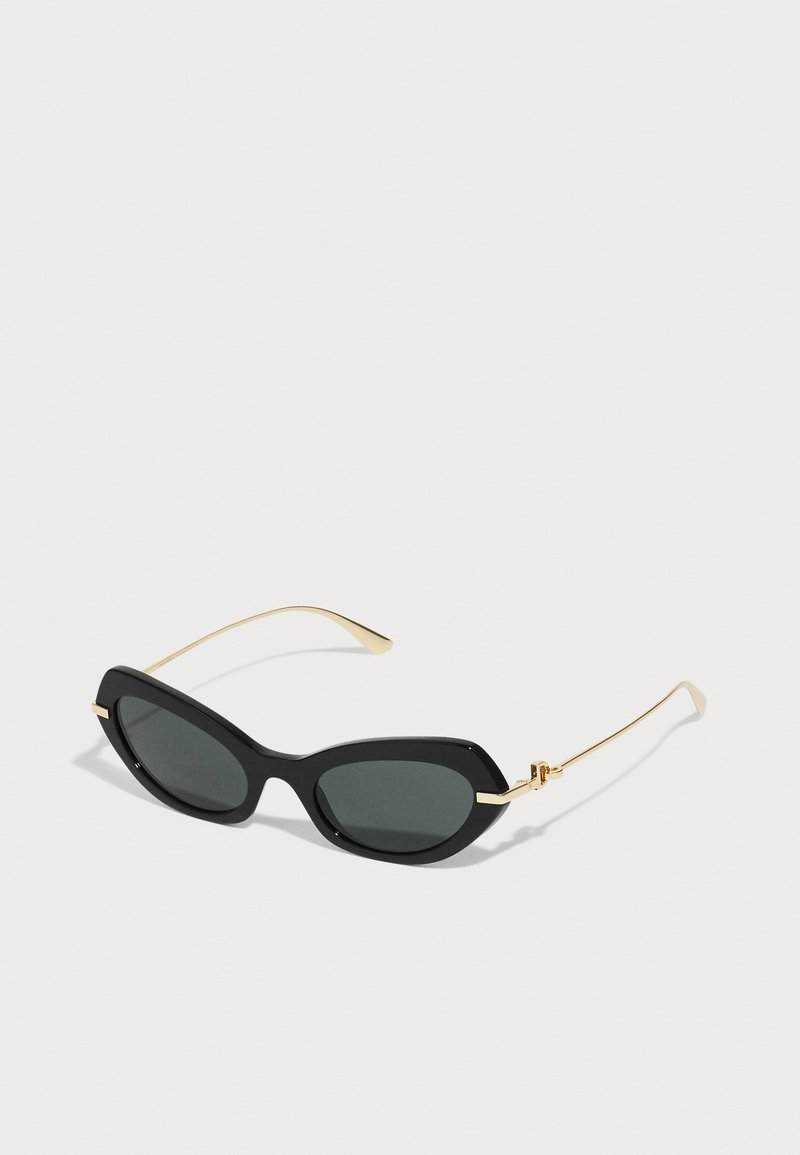 Black sunglasses with a sleek, cat-eye design, featuring gray lenses and gold-tone metal accents on the temples.