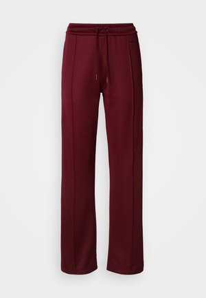 Burgunderfargede joggebukser med elastisk midje, snøring og sidesømmer. Laget av mykt, stretchbart stoff. Egnet for uformell bruk.