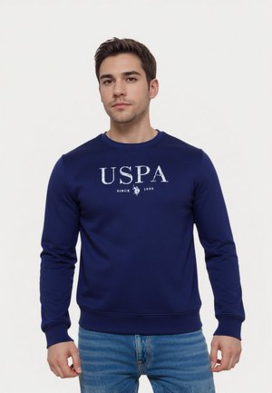 Felpa blu navy realizzata in morbido tessuto, con un logo bianco stampato "USPA" e il testo "SINCE 1980" sul petto. Maniche lunghe.
