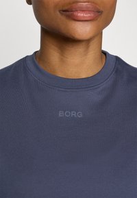 Navy blue cotton t-shirt with a round neckline. Features a small, subtle "BORG" logo in a slightly lighter shade on the front. Smooth texture.