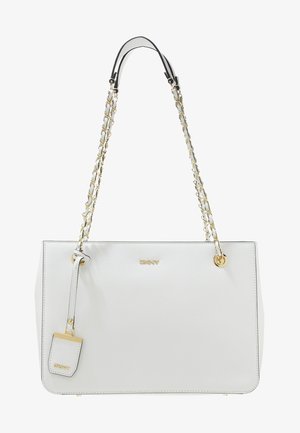 Sac à main en cuir blanc avec des anses en chaîne dorée, logo DKNY doré et une étiquette en cuir blanc assortie suspendue à l'avant.