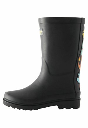Botte de pluie en caoutchouc noire avec des dessins colorés de personnages de dessins animés à l'arrière et une semelle épaisse à crampons.