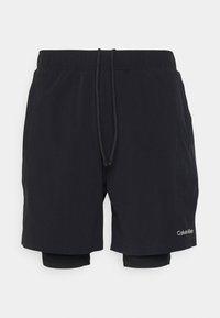 Costumi da bagno neri con vita elastica e lacci. Presentano pantaloncini interni aderenti. Il logo del marchio è stampato in bianco sull'orlo.