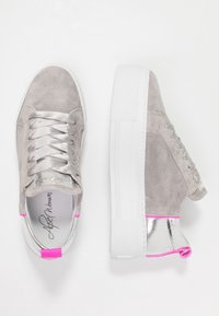 Szare zamszowe sneakersy z srebrnymi akcentami, białą gumową podeszwą, satynowymi sznurówkami i różowymi detalami na pięcie. Prosty design, styl typu low-top.