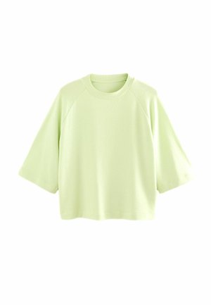 Lys grøn cropped sweatshirt med raglanærmer, ribbet halsudskæring og blød tekstur. Enkelt design uden mønstre eller accenter.