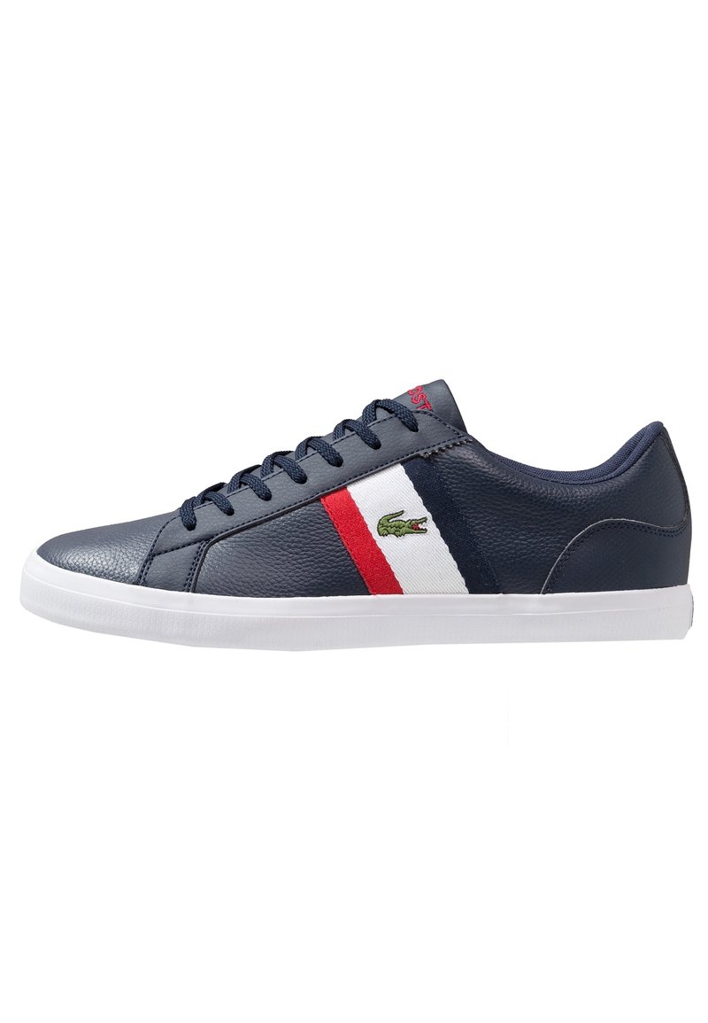 Navy leather sneakers featuring a red and white stripe, with a green logo on the side and a white rubber sole.
