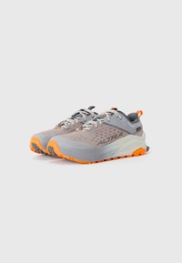 Lightweight trail running shoes in gray and orange. Features mesh upper, Vibram outsole for traction, and reflective accents on laces.