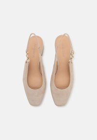 Beige suede slingback shoes with a square toe and low heel, featuring a gold-tone hardware detail on the strap. Smooth inner lining.