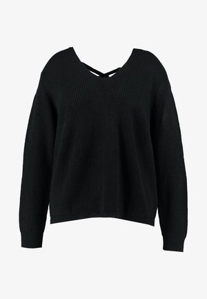 Svart, oversized strikkegenser med V-hals og kryssryggdesign. Har ribbestrikkede mansjetter og nederkant for ekstra tekstur.