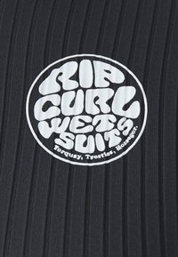 Black wetsuit fabric with vertical ribbing texture. Features a white circular logo with "RIP CURL WETSUITS" text and location details inside.