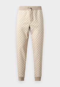 Μπεζ παντελόνι jogger με ελαστική μέση και κορδόνι, με ριμπ μανσέτες και επαναλαμβανόμενο σχέδιο λογότυπου. Απαλή υφή.