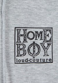 Tessuto grigio con un design grafico nero. Il testo recita "HOME BOY" in un carattere grassetto con accenti decorativi. Sotto, è inclusa la dicitura "loud.couture".