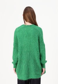 Grønn, luftig, oversized strikkegenser med rund hals og lange ermer, med en myk tekstur og avslappet passform.